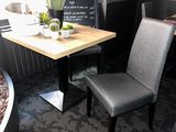 a small table with two chairs and a plant on it