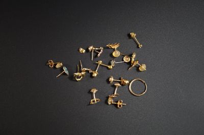un gros plan sur un ensemble de clous dorés posés sur une surface noire