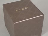 a brown box with the word gucci written on it