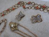 several pieces of jewelry sitting on top of a table next to each other