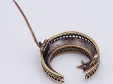 a gold bracelet with a bird on top of it