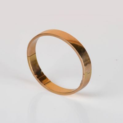 a close up of a gold ring on a white surface