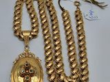 un gros plan sur un collier en or et une chaîne ornée d'un médaillon