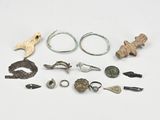 Plusieurs types d'objets métalliques sont exposés sur une surface blanche