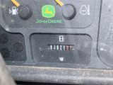 a close up of a car dashboard with a john deere button