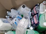 a cardboard box filled with bottles and containers of cleaning products