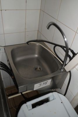 a sink and a washing machine in a small room