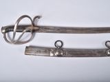 two old swords are laying side by side on a white surface