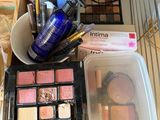 a lot of makeup and makeup products on the counter