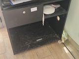 a small desk with a drawer underneath it in a room