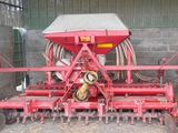 a red machine that is sitting in the dirt