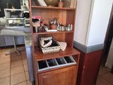 a wooden cabinet with a drawer on top of it