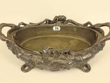 an antique silver plate with a bird design on it