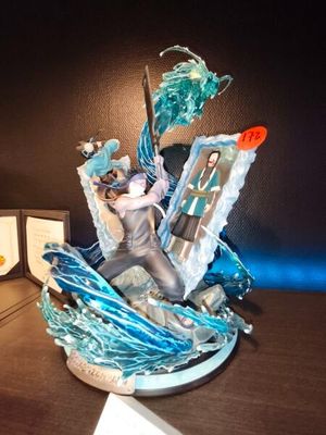 a figurine of a person on a boat on a desk