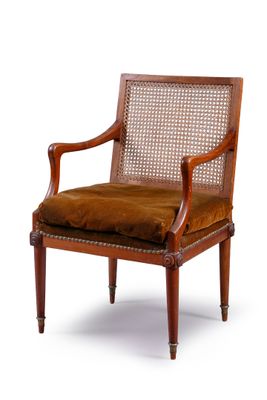 the chair is made of wood and has a brown upholstered seat