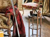 un salon avec un canapé, un fauteuil, une table et une épée