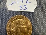 a close up of a gold coin with a label on it