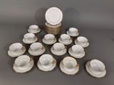 a lot of cups and saucers sitting on a table