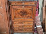 a small chest of drawers in a room next to a door