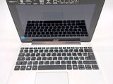 a laptop computer with a keyboard on a white surface