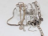 a small clear box with a bunch of jewelry inside of it