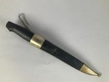a black and gold pen sitting on top of a white table