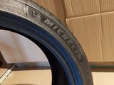 a close up of a tire on a wooden floor next to a cardboard box