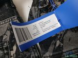 the label on the back of a pair of jeans is attached to the back of a jacket