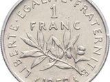 an old french 1 franc coin on a white background