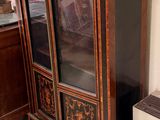 a cabinet with a glass door in a room