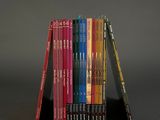 books stacked on top of each other on a black surface