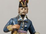 figurine of a man in a military uniform holding a sword