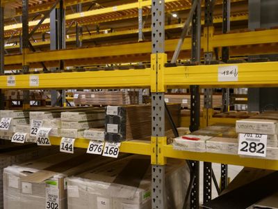 many boxes on the shelves in the warehouse