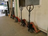four hand trucks that are lined up against the wall