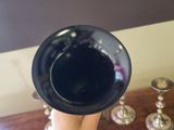 a person holding a glass of wine on a table