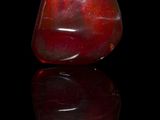 an image of a red glass vase on a black surface