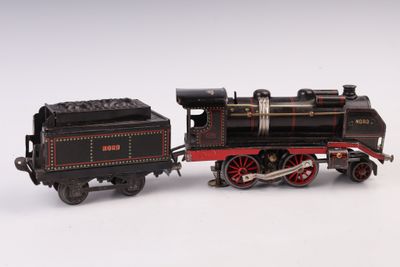 un train noir et rouge sur un fond blanc