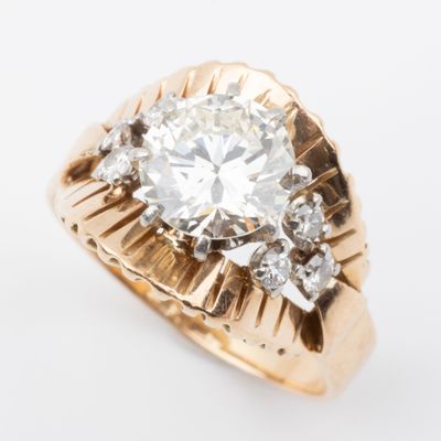 a close up of a diamond ring on a white surface