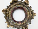 an old metal object on a white surface with a white background