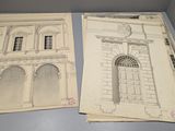 deux anciens plans architecturaux d'un bâtiment posés sur une table