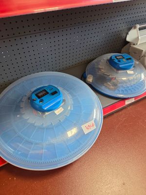 two plastic plates with lids on them on a shelf