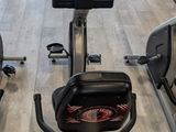 a row of stationary exercise bikes in a gym
