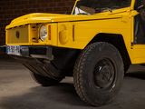 a yellow truck that is parked in a garage
