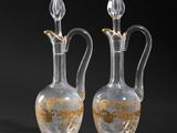 two clear glass vases sitting next to each other on a black surface
