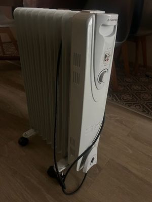 a white radiator sitting on the floor in a living room
