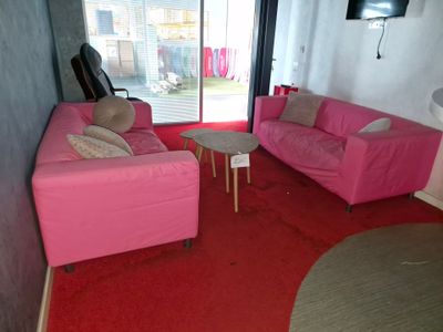 a pink couch and a pink chair in a living room
