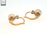 pair of pearl and gold earrings on a white background