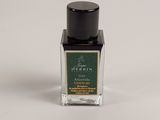 a bottle of perfume sitting on top of a white table