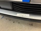 a close up of the front of a car with a license plate on it