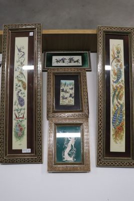 four framed pictures hanging on the wall of a room